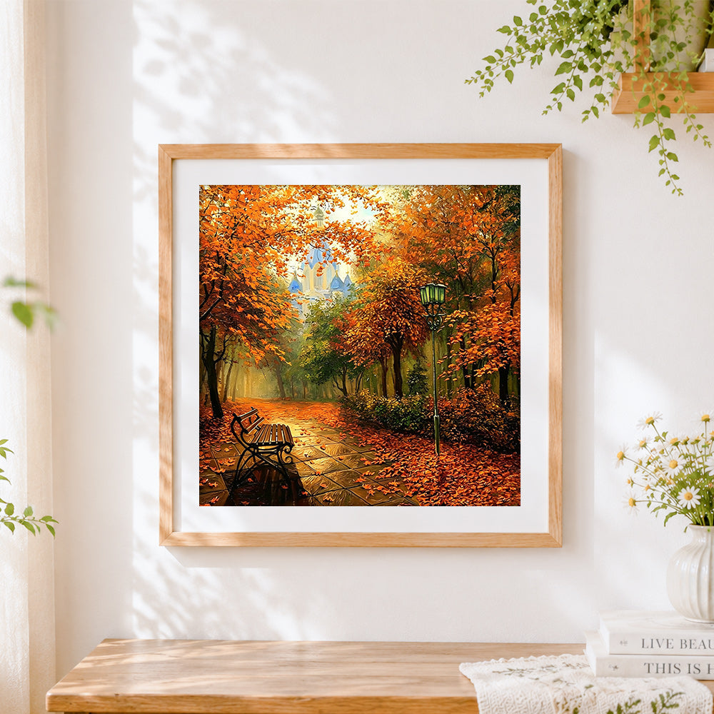 Finished autumn park bench and castle cross stitch artwork displayed