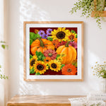 Finished autumn pumpkins and sunflowers pattern cross stitch artwork displayed