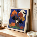 Autumn tree ghost punch needle artwork displayed on a table