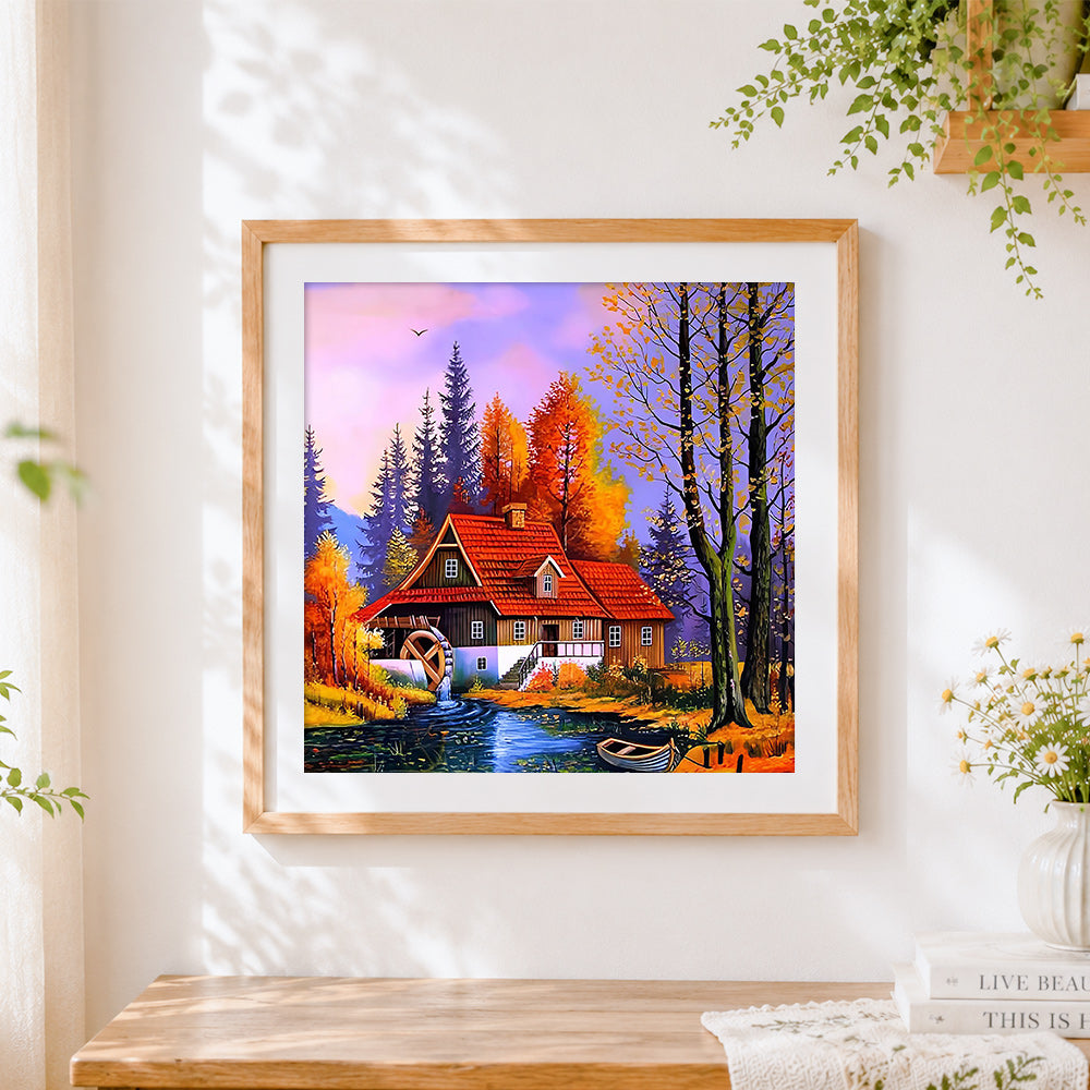 Finished autumn watermill cottage cross stitch artwork displayed