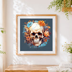Finished autumnal floral skull cross stitch artwork displayed