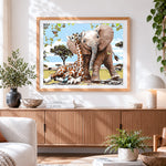 Finished baby elephant and giraffe cross stitch artwork displayed