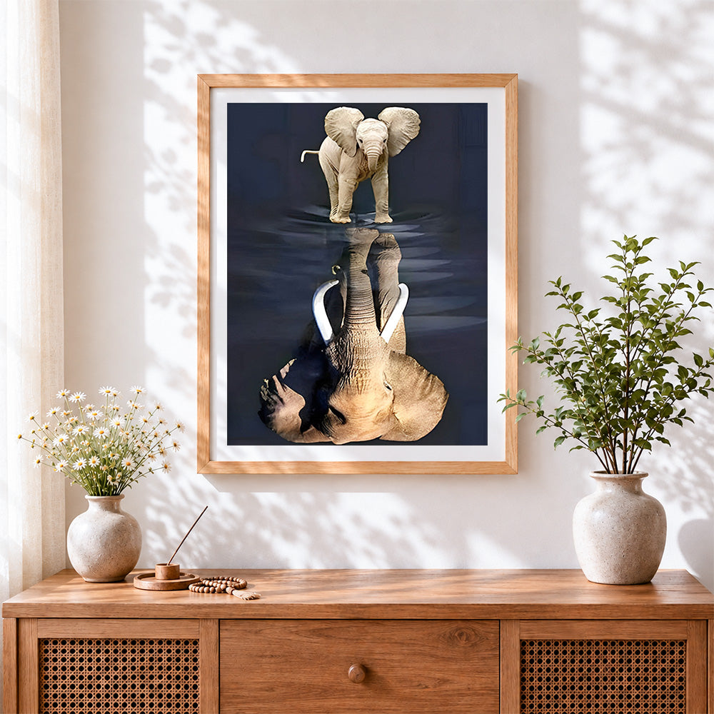 Finished baby elephant and reflection cross stitch artwork displayed