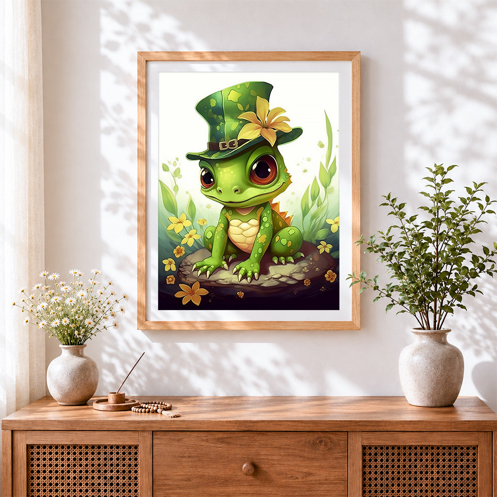 Finished baby frog with top hat cross stitch artwork displayed
