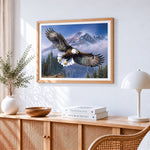 Bald eagle flying over snowy mountains cross stitch artwork displayed on wall as home decor