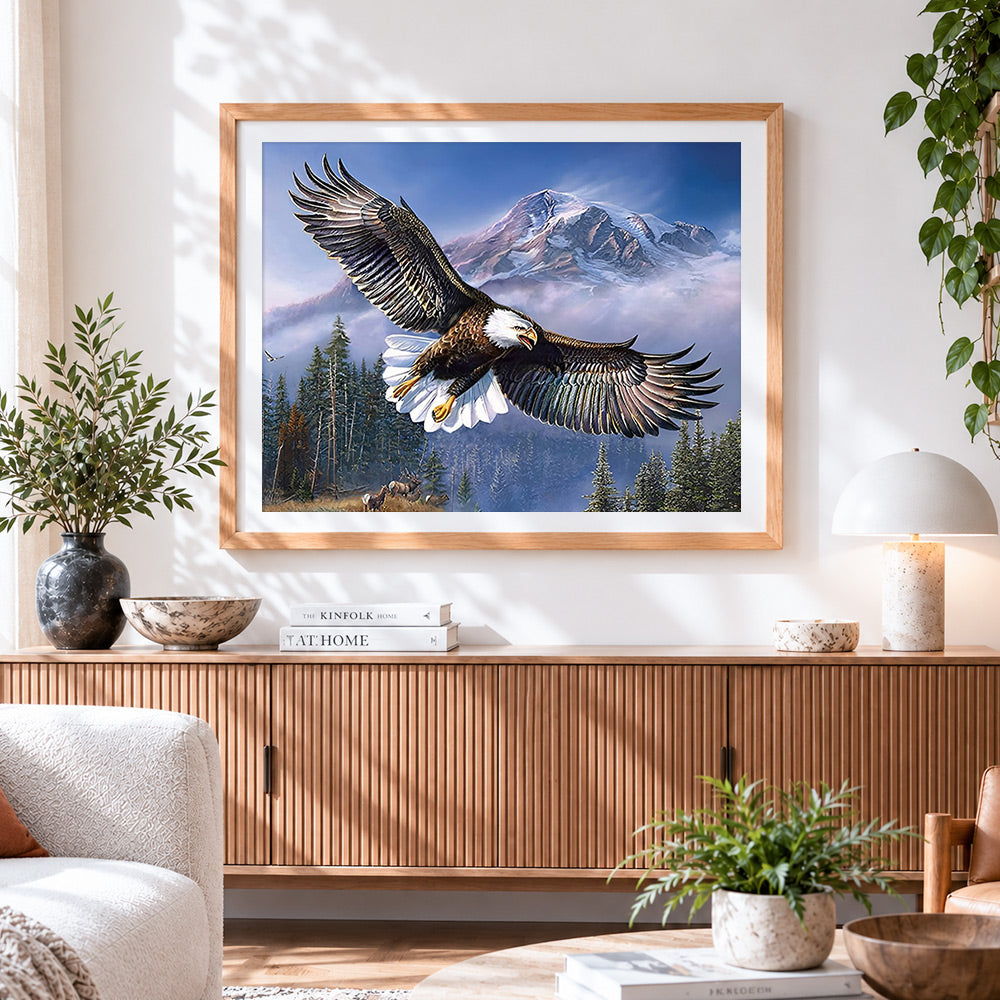 Finished bald eagle flying over snowy mountains paint by numbers artwork displayed as home decor