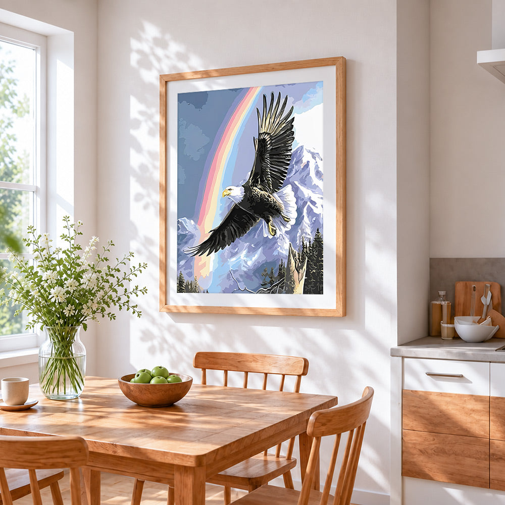 Bald eagle rainbow and snowy mountain cross stitch artwork displayed on wall as home decor