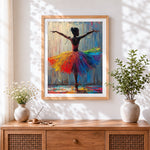 Finished ballerina with rainbow tutu cross stitch artwork displayed