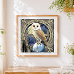 Finished barn owl with pentagram cross stitch artwork displayed