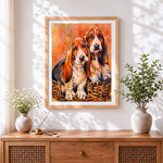 Finished basset hounds in a basket cross stitch artwork displayed