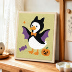 Bat costume duck punch needle artwork displayed on a table