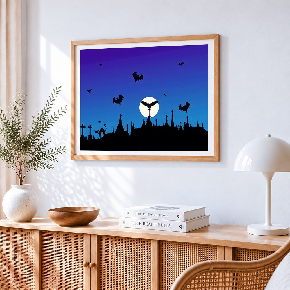 Bat silhouettes over a graveyard cross stitch artwork displayed on wall as home decor