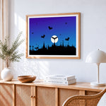 Bat silhouettes over a graveyard cross stitch artwork displayed on wall as home decor