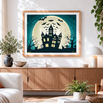 Finished bats flying over haunted house and full moon cross stitch artwork displayed