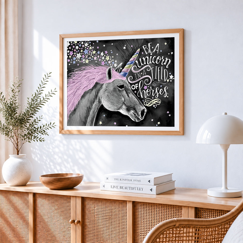 Be a unicorn in a field of horses cross stitch artwork displayed on wall as home decor