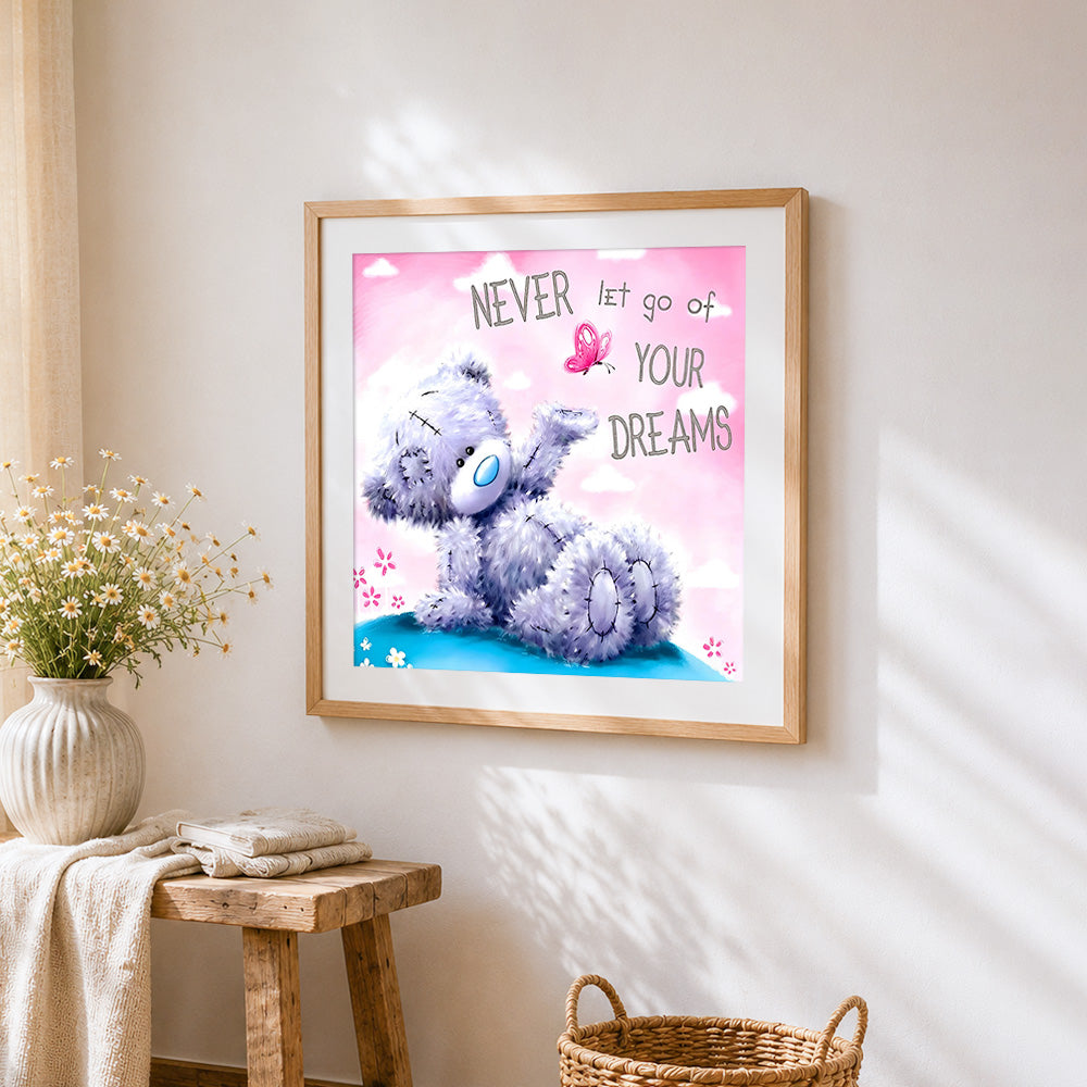 Bear and "never let go of your dreams" cross stitch artwork displayed on wall as home decor