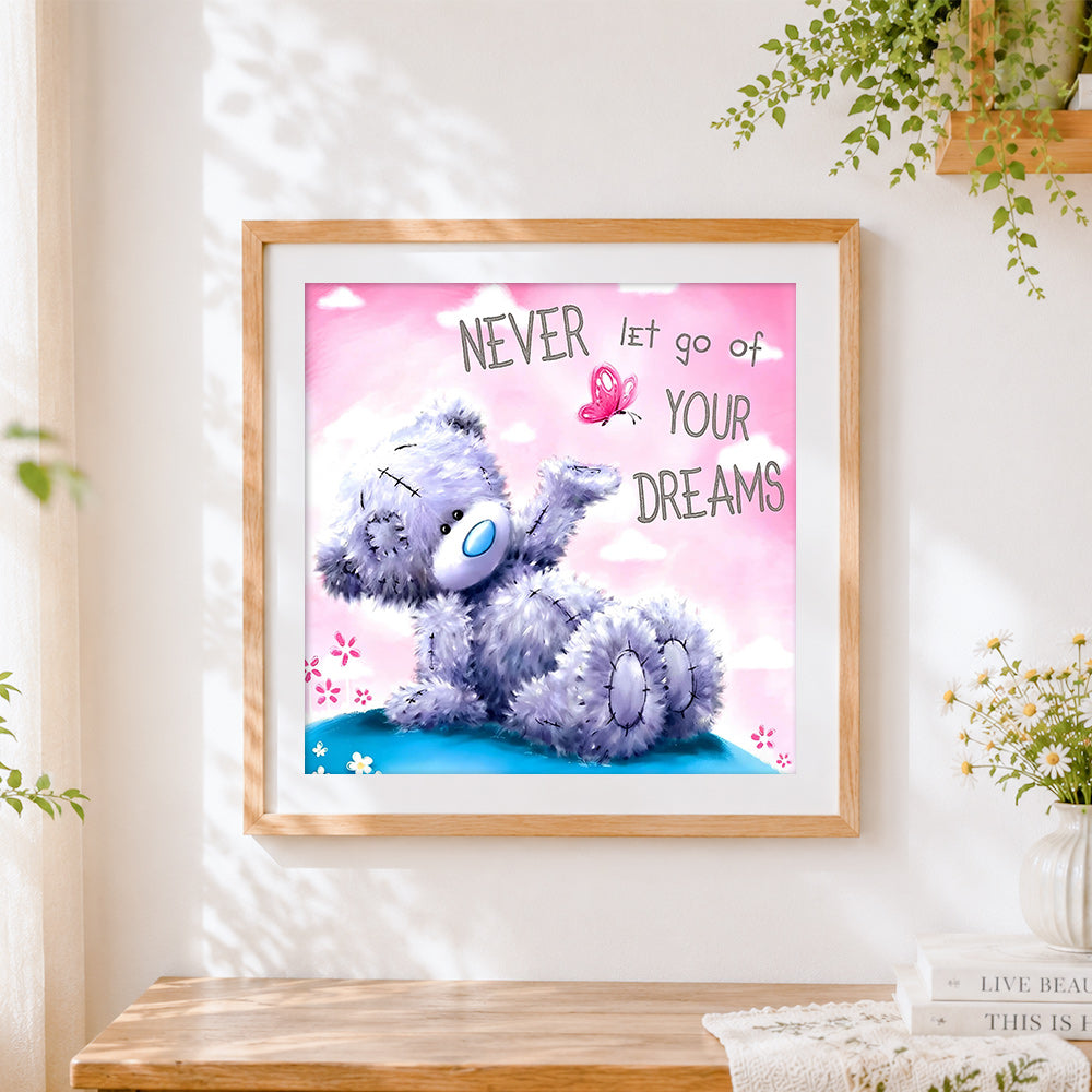 Finished bear and "never let go of your dreams" paint by numbers artwork displayed as home decor