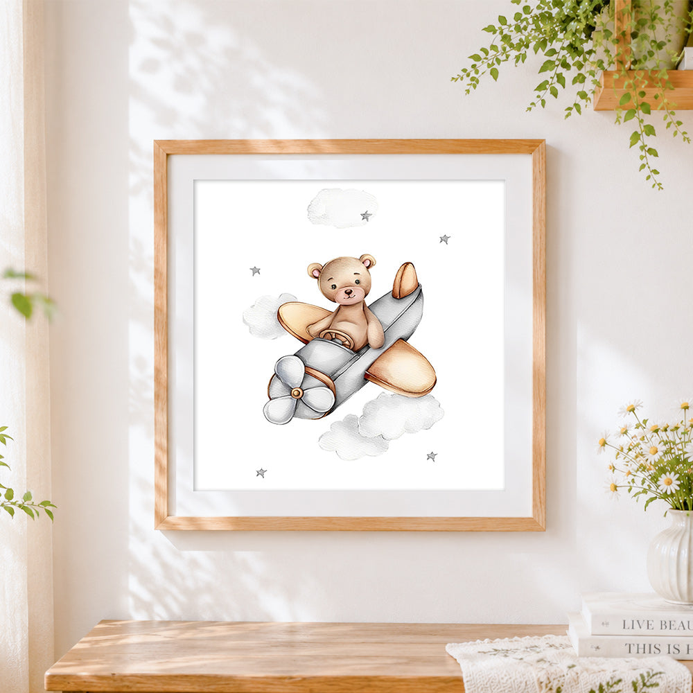 Finished bear flying a plane cross stitch artwork displayed