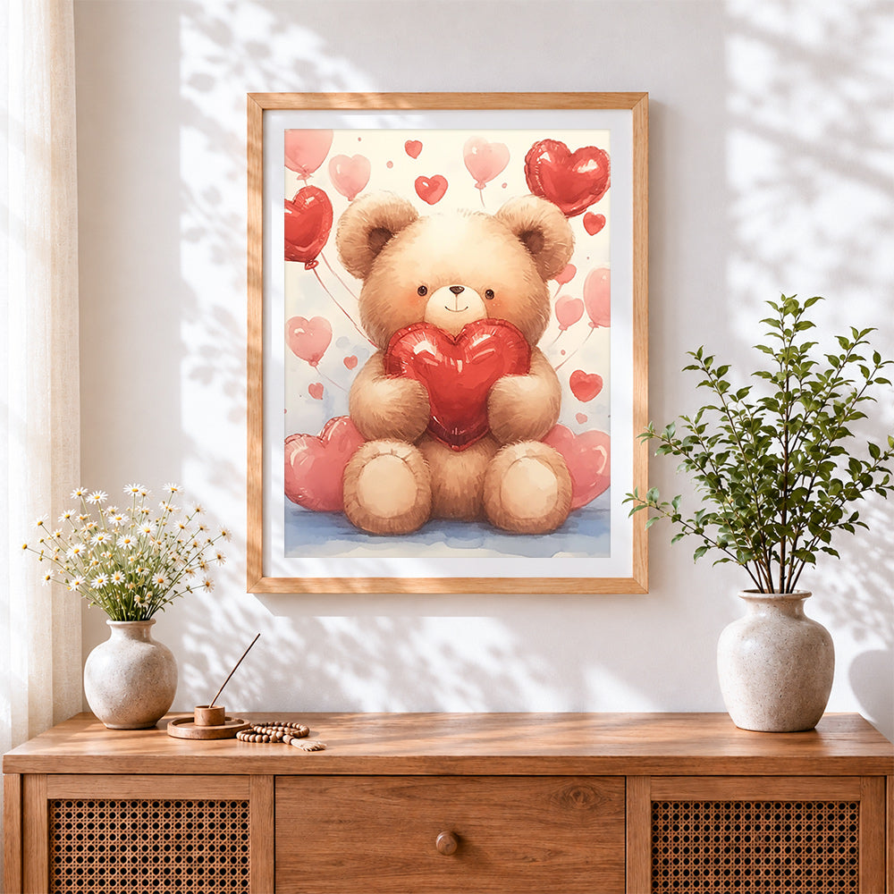 Finished bear holding a red heart cross stitch artwork displayed