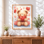 Finished bear holding a red heart cross stitch artwork displayed