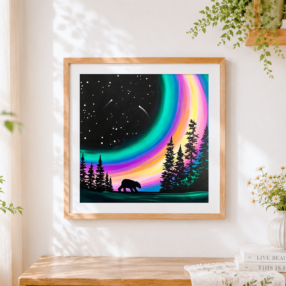 Finished bear under rainbow aurora cross stitch artwork displayed