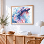 Beautiful pink and blue betta fish cross stitch artwork displayed on wall as home decor