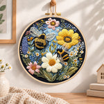Bees and sunny wildflowers embroidery hoop wall art displayed as warm and cozy handmade home decor