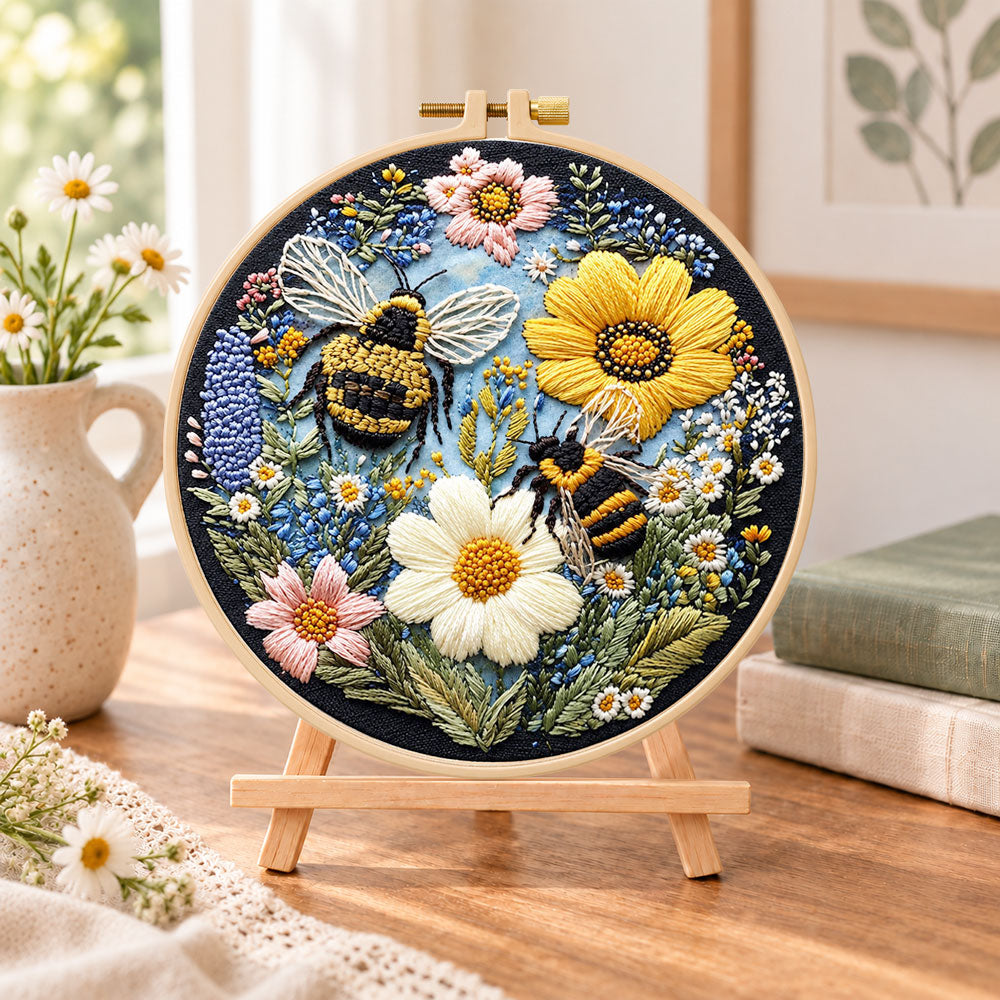 Bees and sunny wildflowers embroidery kit finished hoop displayed on a wooden stand as cozy tabletop decor