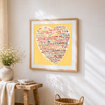 Beige multi language i love you heart cross stitch artwork displayed on wall as home decor