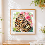 Finished bengal cat and kitten cross stitch artwork displayed