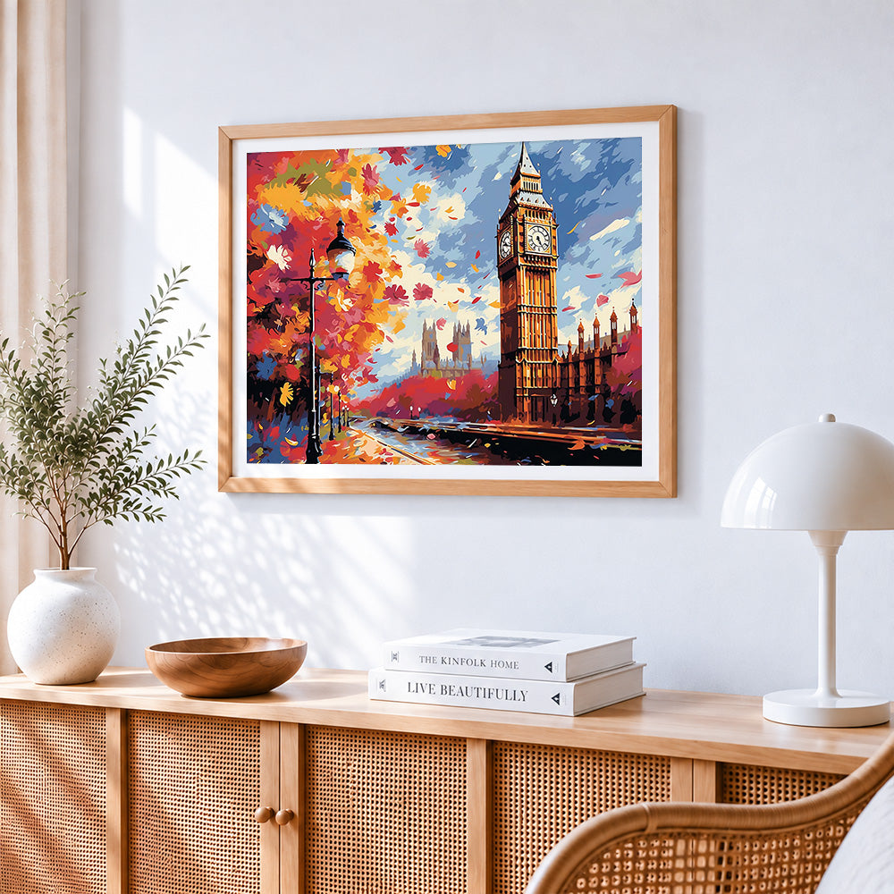 Big ben and falling leaves cross stitch artwork displayed on wall as home decor