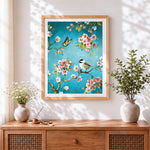 Finished bird and butterfly on blossom branch cross stitch artwork displayed