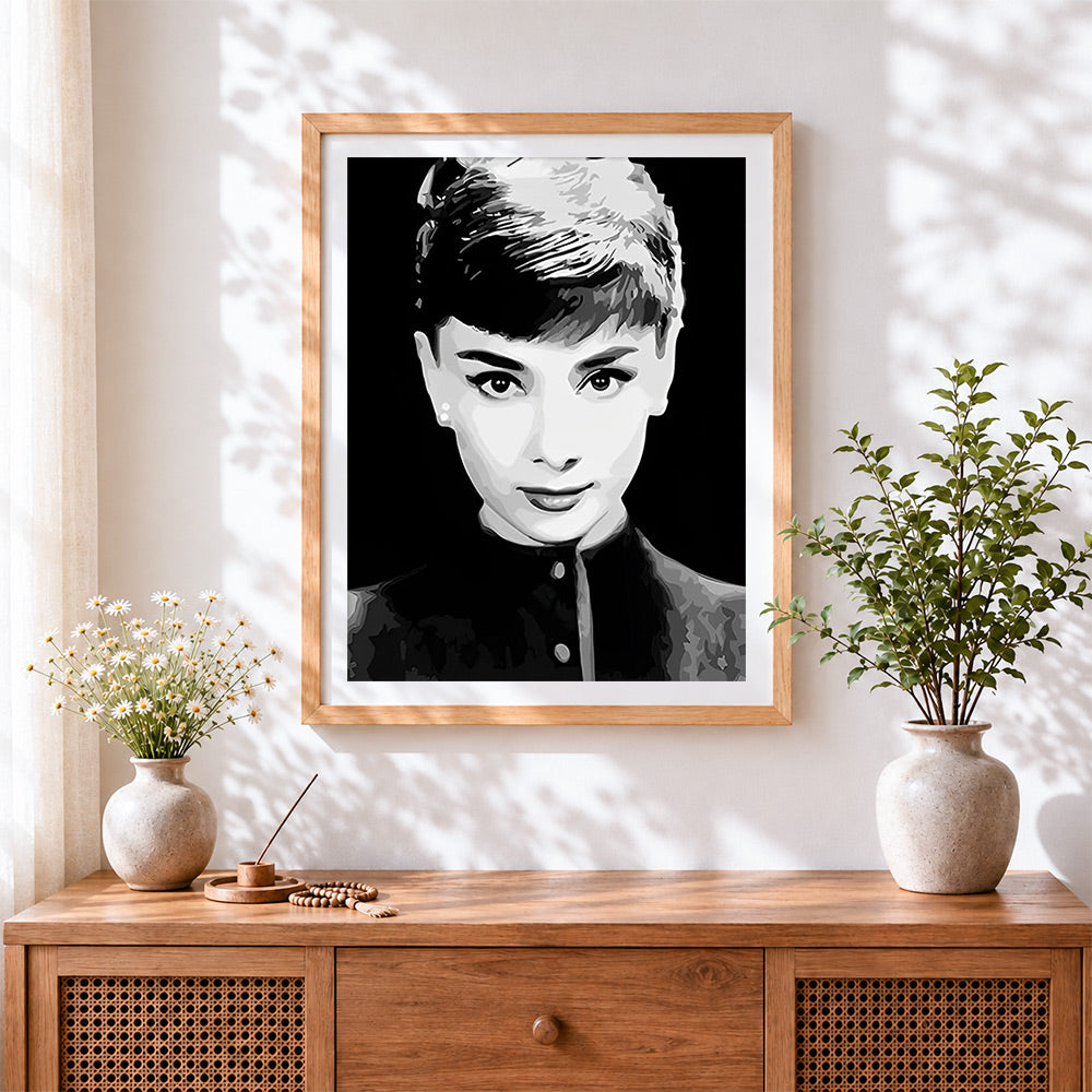 Finished black and white audrey hepburn portrait cross stitch artwork displayed