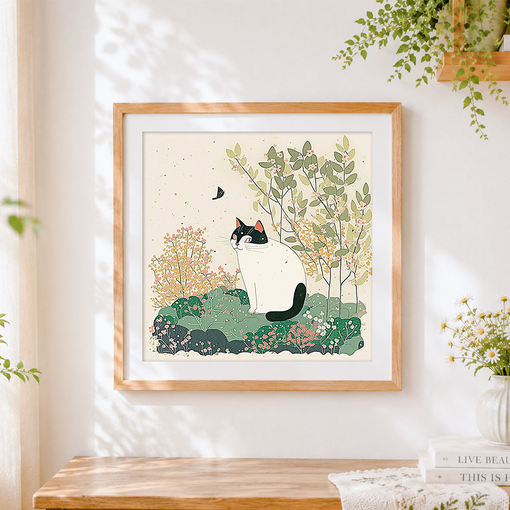 Finished black and white cat in spring cross stitch artwork displayed