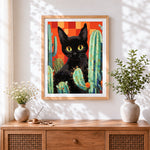 Finished black cat and cacti cross stitch artwork displayed