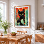 Black cat and cacti cross stitch artwork displayed on wall as home decor
