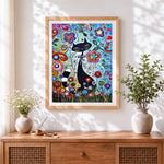 Finished black cat and flowers cross stitch artwork displayed