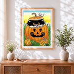 Finished black cat and mouse in pumpkin cross stitch artwork displayed