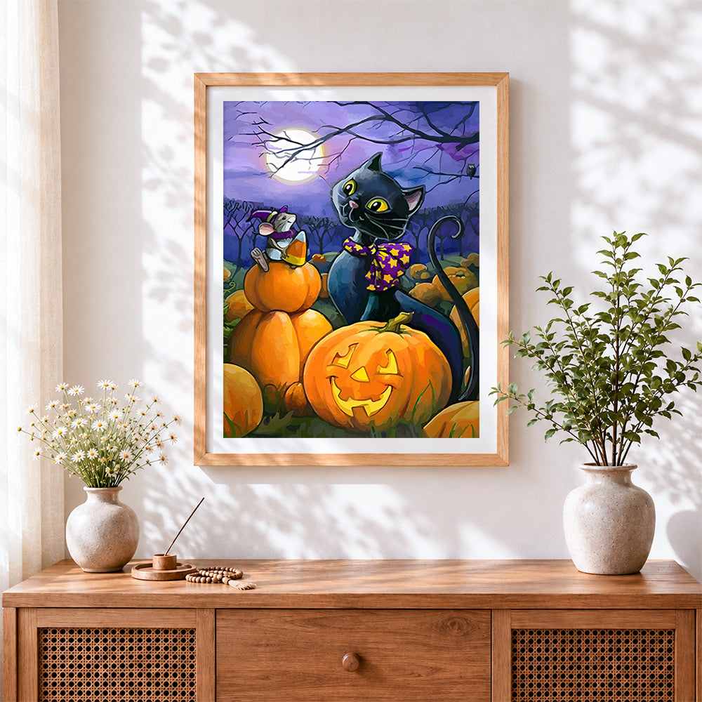 Finished black cat and mouse with candy corn cross stitch artwork displayed