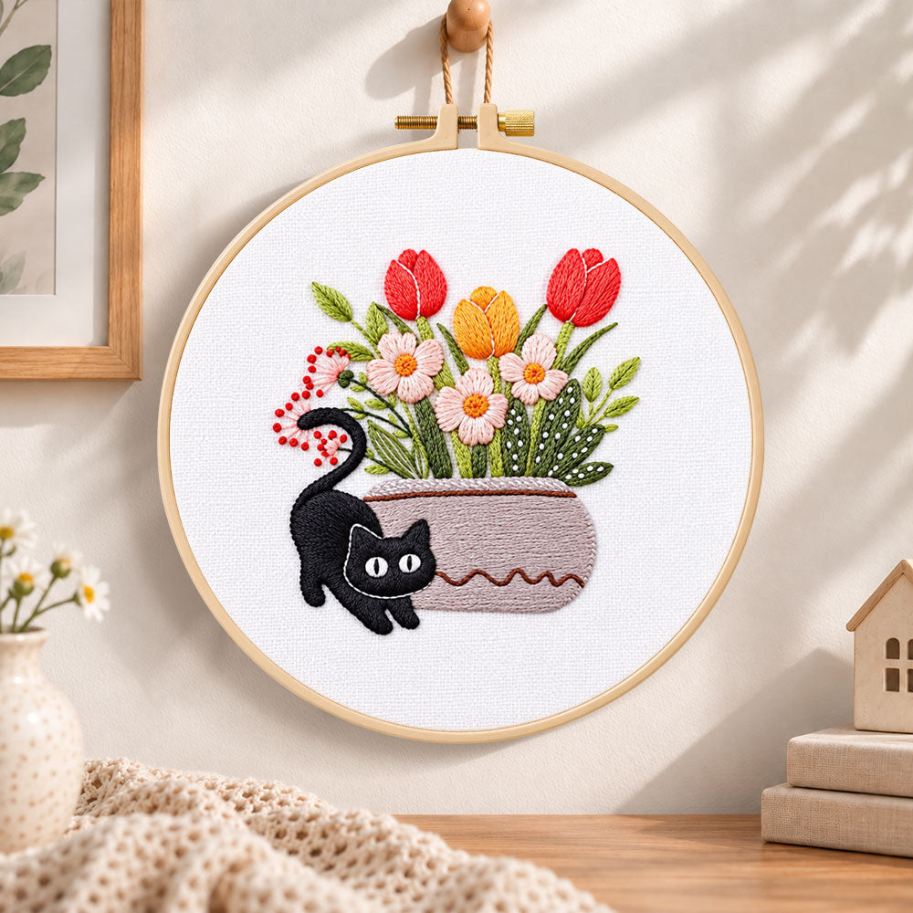 Black cat and tulips embroidery hoop wall art displayed as warm and cosy handmade home decor