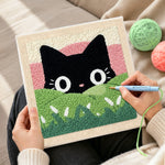 Creating handmade black cat in green meadow punch needle artwork