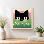 Finished black cat in green meadow artwork displayed on a wall