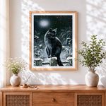 Finished black cat in snowy night cross stitch artwork displayed
