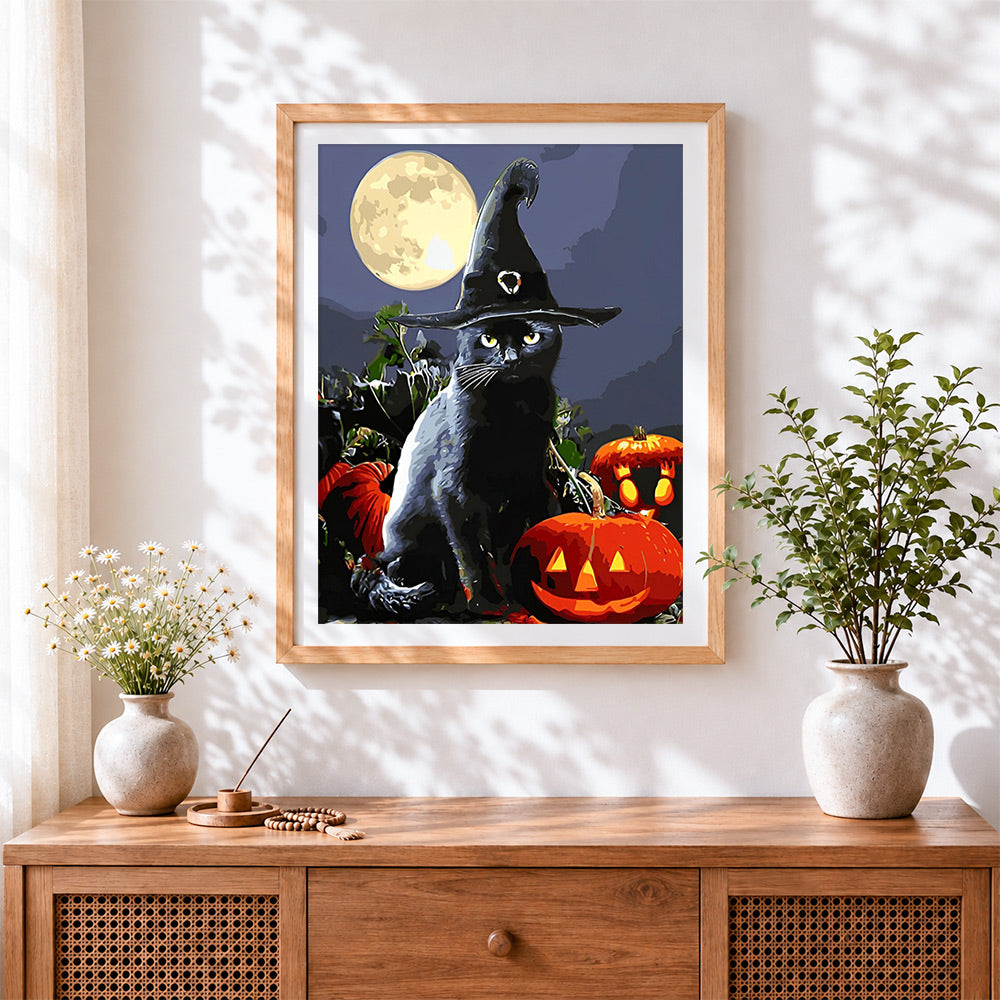 Finished black cat in witch hat with full moon cross stitch artwork displayed