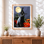 Finished black cat in witch hat with full moon cross stitch artwork displayed