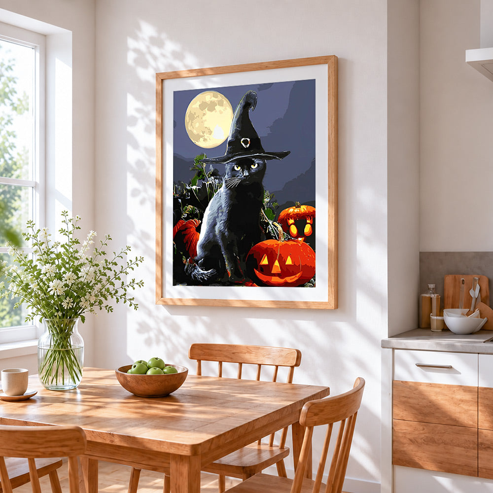 Black cat in witch hat with full moon cross stitch artwork displayed on wall as home decor
