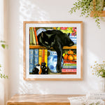 Finished black cat lounging on a bookshelf cross stitch artwork displayed