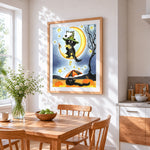 Black cat on crescent moon cross stitch artwork displayed on wall as home decor