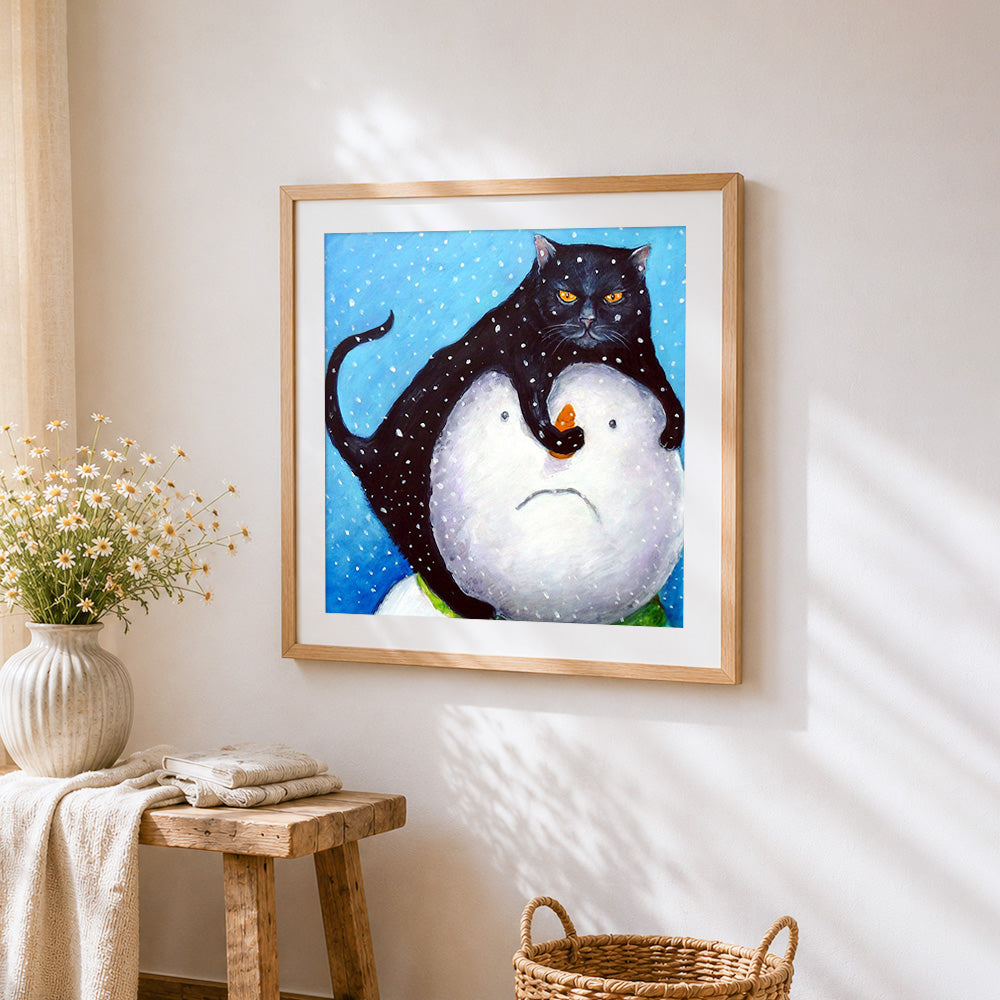 Black cat on snowman cross stitch artwork displayed on wall as home decor