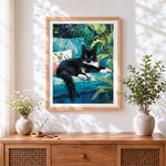 Finished black cat on teal sofa cross stitch artwork displayed